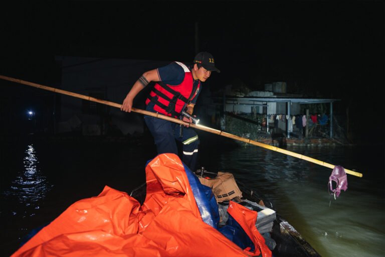 Rescuers on boat searching for survivors in the dark