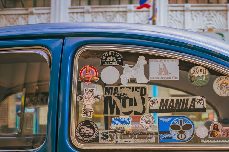 Old beetle car window with multiple classic stickers