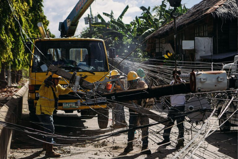 Road cleanup operation removing a damaged electric post
